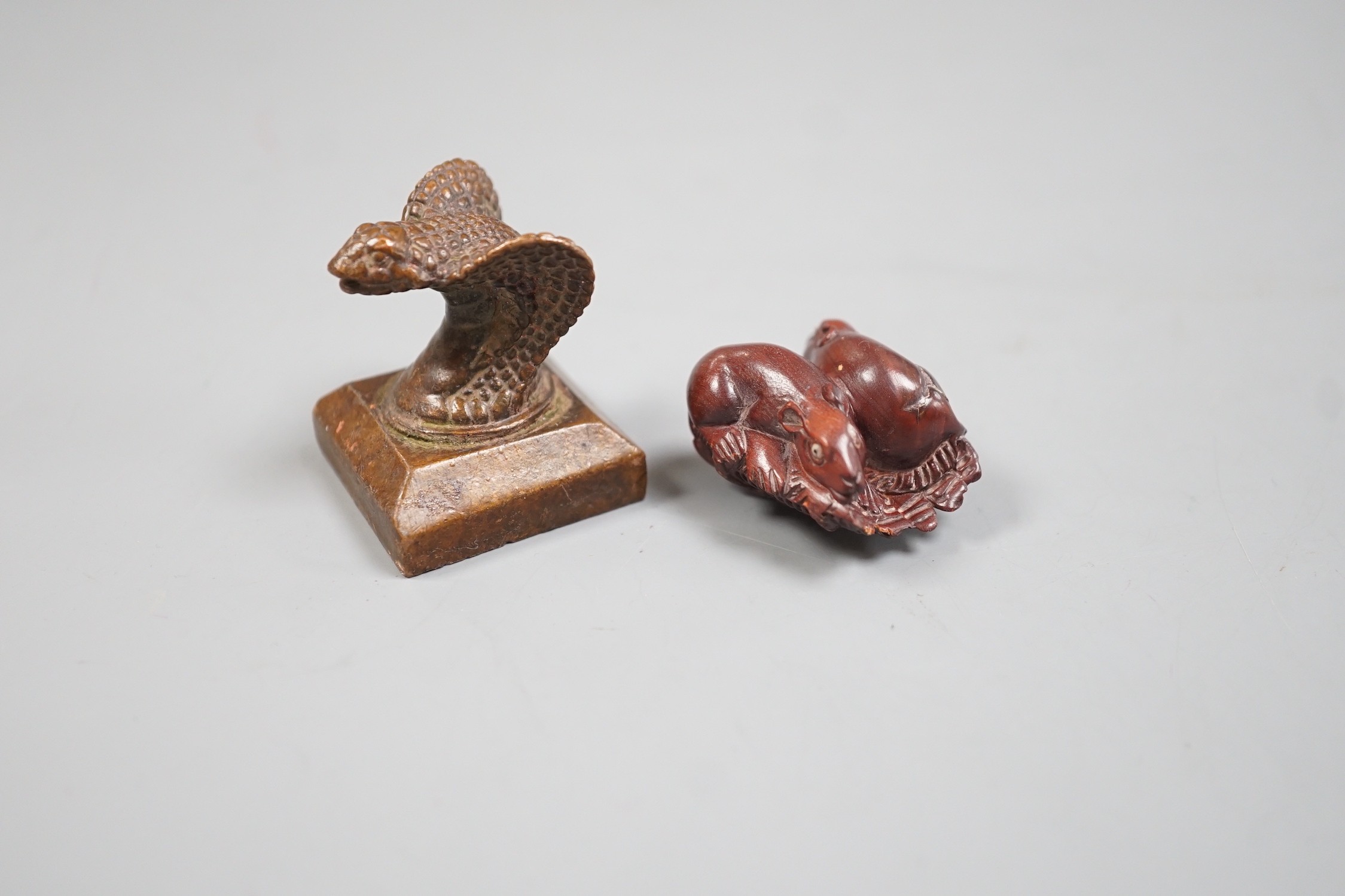 A Chinese bronze 'cobra' seal and a Japanese carved wood netsuke with signed mother of pearl tablet to underside. Seal 4cm tall